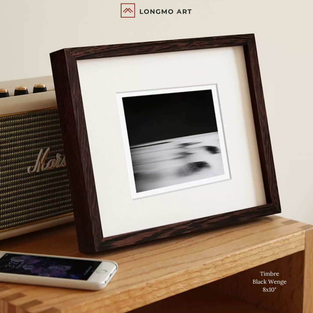 Framed artwork on a wooden surface with a Marshall amplifier and smartphone in the background, featuring the LONGMO ART brand.