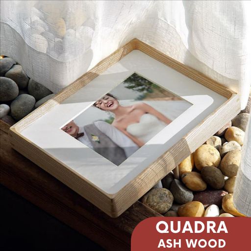 Wooden photo album with images of a couple on pebbles and fabric background, featuring 'Quadra Ash Wood' text.