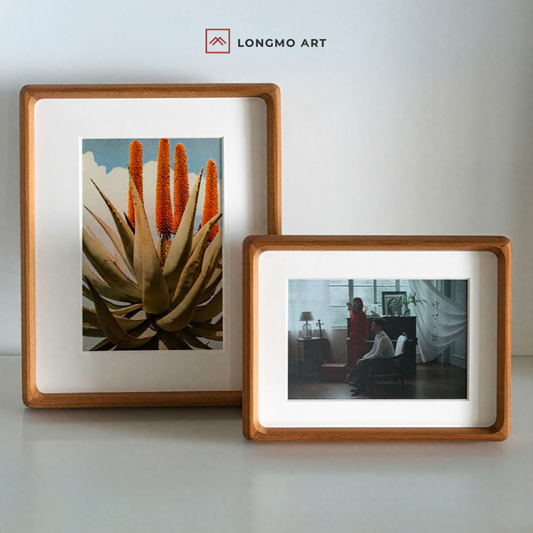 Two solid wood picture frames with clear glass, one larger displaying a photo of an aloe plant and the other smaller with a white mat. Both have a smooth, rounded corner design and are without visible screws or paints.