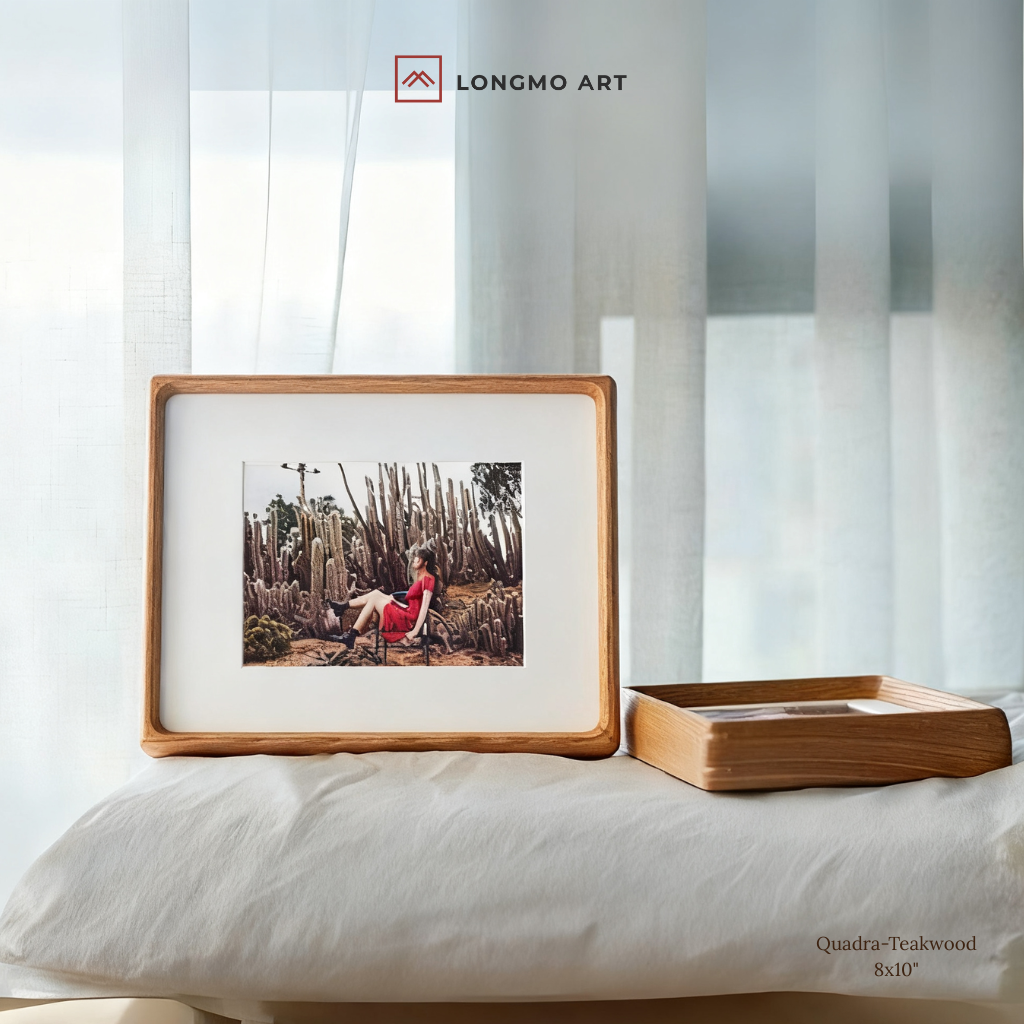 Framed photograph of a person in a red dress sitting among cacti, with 'LONGMO ART' branding.