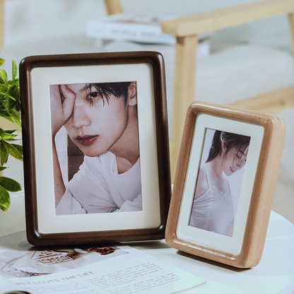 Handcrafted solid wood frame on desk with easel stand, holding a printed portrait